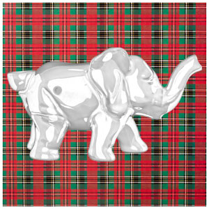 A white elephant pipe on a plaid wrapping paper background.